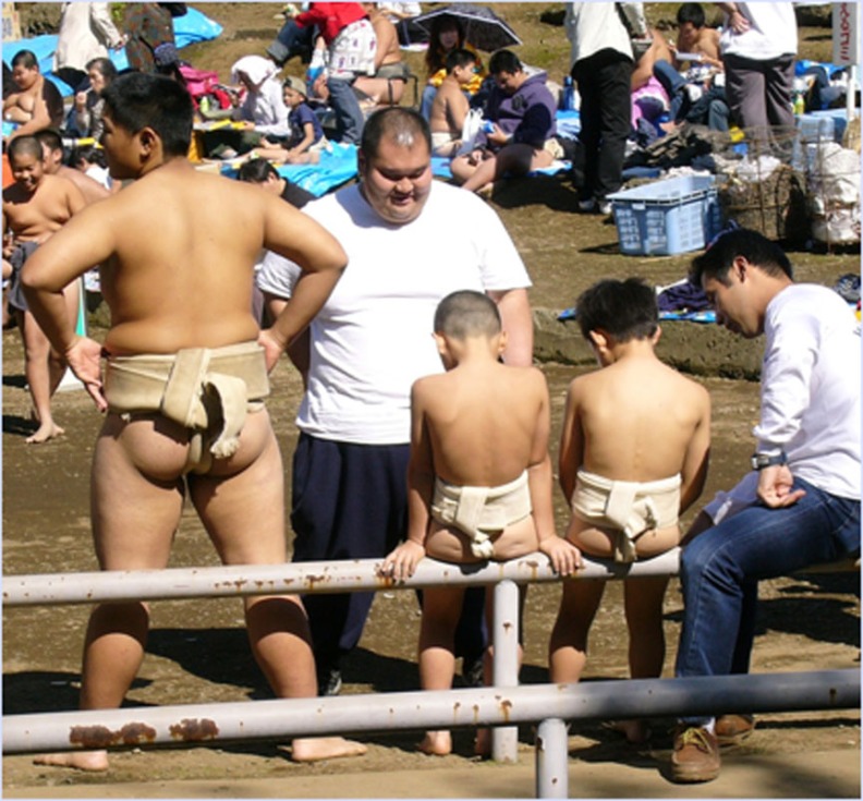 Big and little sumo wrestlers at an amateur tournament at the Yasukuni Shrine